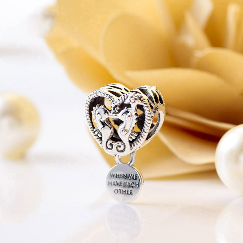 Hollow seahorse pattern heart charm
